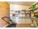 Organized storage area with brick accents and open shelving, perfect for tools and lawn equipment at 4420 E Covina St, Mesa, AZ 85205