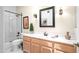 Well-lit bathroom featuring a vanity, decorative mirror, and walk-in shower with white tile surround at 4748 E Eden Dr, Cave Creek, AZ 85331