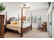 Bedroom features a wooden four-poster bed, ceiling fan, and large window offering plenty of natural light at 4748 E Eden Dr, Cave Creek, AZ 85331