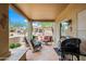 Inviting covered patio featuring stylish seating and grill for outdoor relaxation and entertainment at 4748 E Eden Dr, Cave Creek, AZ 85331