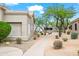 Exterior view of a well-maintained home with desert landscaping and a private walkway at 4748 E Eden Dr, Cave Creek, AZ 85331