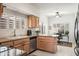 Functional kitchen featuring light wood cabinets, granite countertops, stainless appliances, and convenient desk area for everyday living at 4748 E Eden Dr, Cave Creek, AZ 85331
