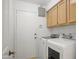 Practical laundry room equipped with modern washer, dryer, and built in storage cabinets above at 4748 E Eden Dr, Cave Creek, AZ 85331