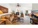 Cozy living room featuring a fireplace, comfortable seating, and seamless access to the outdoor patio and dining area at 4748 E Eden Dr, Cave Creek, AZ 85331