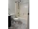 Well-lit bathroom features neutral tile flooring and a white shower tub at 525 N Miller Rd # 239, Scottsdale, AZ 85257