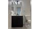 Bathroom featuring a black vanity with white countertop, rectangle mirror and modern lighting at 525 N Miller Rd # 239, Scottsdale, AZ 85257