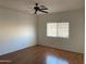 Bedroom with neutral walls, ceiling fan, and wood flooring at 525 N Miller Rd # 239, Scottsdale, AZ 85257