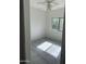 Bright bedroom featuring a ceiling fan, tile flooring, and natural light from the window at 525 N Miller Rd # 239, Scottsdale, AZ 85257