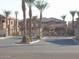 Gated community entrance with lush palm trees at 525 N Miller Rd # 239, Scottsdale, AZ 85257