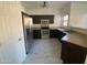 A kitchen featuring stainless steel appliances, tile flooring, and dark wood cabinets at 525 N Miller Rd # 239, Scottsdale, AZ 85257
