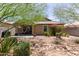 Cozy backyard with desert landscaping, patio seating, and flowering bushes at 652 E Rojo Way, Gilbert, AZ 85297