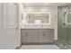 This primary bathroom features a dual sink vanity and luxurious glass enclosed shower at 652 E Rojo Way, Gilbert, AZ 85297