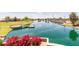 Serene Layton Lakes community waterfront featuring grassy common areas, walking paths, a dock, and lush landscaping at 652 E Rojo Way, Gilbert, AZ 85297