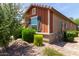 Corner view of a single-story home with tidy landscaping and dark shutters at 652 E Rojo Way, Gilbert, AZ 85297