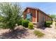 Corner view of a single-story home with tidy landscaping and dark shutters at 652 E Rojo Way, Gilbert, AZ 85297