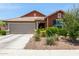 Charming single-story home with a well-maintained front yard and attached two-car garage at 652 E Rojo Way, Gilbert, AZ 85297