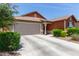 Single-story home featuring a 2-car garage, neutral color palette and tidy landscape in front at 652 E Rojo Way, Gilbert, AZ 85297