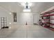 Large two-car garage with epoxy flooring, storage racks, and water heater at 652 E Rojo Way, Gilbert, AZ 85297