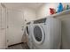 A well-equipped laundry room with modern washer and dryer units and storage space at 652 E Rojo Way, Gilbert, AZ 85297