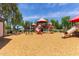 Vibrant community playground featuring slides and climbing structures on a wood chip surface at 652 E Rojo Way, Gilbert, AZ 85297