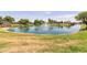 A tranquil view of a pond with fountain, green space, gazebo, and playground available for residents and their guests at 652 E Rojo Way, Gilbert, AZ 85297