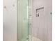 A close up view of the glass enclosed shower with built in shelves and silver hardware at 652 E Rojo Way, Gilbert, AZ 85297