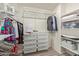 Organized walk-in closet with multiple racks and shelves for storing clothes and accessories at 652 E Rojo Way, Gilbert, AZ 85297