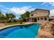 View of the backyard pool, mature landscaping, and covered patio, blending leisure and relaxation at 6637 W Watkins St, Phoenix, AZ 85043
