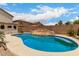 A backyard view shows the pool has custom rock features, mature landscaping and is fenced for privacy at 6637 W Watkins St, Phoenix, AZ 85043