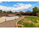 Backyard view of the pool showing mature landscaping and a built-in barbecue area at 6637 W Watkins St, Phoenix, AZ 85043