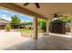 Covered patio showing spacious backyard, mature landscaping, outdoor kitchen, and storage shed at 6637 W Watkins St, Phoenix, AZ 85043