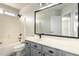 Gray vanity complements the bathtub in this bright bathroom at 6637 W Watkins St, Phoenix, AZ 85043