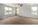 Expansive bedroom with carpet floors, a ceiling fan, and abundant natural light at 6637 W Watkins St, Phoenix, AZ 85043