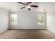 Large bedroom with carpet floors, a ceiling fan, and large windows at 6637 W Watkins St, Phoenix, AZ 85043