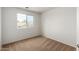 Bedroom features neutral carpet, window, and fresh white paint at 6637 W Watkins St, Phoenix, AZ 85043
