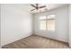 Neutral carpeted bedroom with a ceiling fan and a window at 6637 W Watkins St, Phoenix, AZ 85043