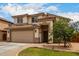 Charming two-story home with a two-car garage, manicured front yard, and desert landscaping at 6637 W Watkins St, Phoenix, AZ 85043