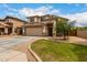 Charming two-story home with a two-car garage, a strip of green lawn, and desert landscaping at 6637 W Watkins St, Phoenix, AZ 85043