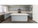 Spacious kitchen boasts an island, stainless appliances, gray cabinets, and white countertops at 6637 W Watkins St, Phoenix, AZ 85043