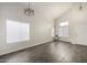 Bright living room featuring wood-look flooring, high ceilings, and large windows for natural light at 6637 W Watkins St, Phoenix, AZ 85043