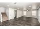 Spacious living room with tile floors, ceiling fan, neutral colors and barn doors at 6637 W Watkins St, Phoenix, AZ 85043