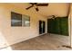 View of the covered patio showcasing ceiling fans, a window and a glass sliding door at 6637 W Watkins St, Phoenix, AZ 85043