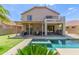 Expansive backyard features a pool, covered patio, and putting green, perfect for outdoor entertainment and relaxation at 6847 S 27Th Pl, Phoenix, AZ 85042