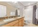 Bathroom featuring dual sink vanity, granite counters, and a shower-tub combo at 6847 S 27Th Pl, Phoenix, AZ 85042