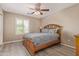 Cozy bedroom features a ceiling fan, window with shutters, and warm lighting at 6847 S 27Th Pl, Phoenix, AZ 85042