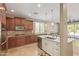 Modern kitchen featuring a center island, quartz countertops, stainless appliances, and backyard views at 6847 S 27Th Pl, Phoenix, AZ 85042
