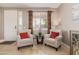 Inviting living room featuring neutral walls, travertine floors, and light-filled window at 6847 S 27Th Pl, Phoenix, AZ 85042