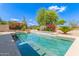 A sparkling swimming pool with vibrant pink bougainvillea and lush landscaping offers a relaxing backyard oasis at 6847 S 27Th Pl, Phoenix, AZ 85042