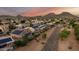 Expansive aerial view of a desert neighborhood with solar panels and mountain backdrop at 6971 W El Cortez Pl, Peoria, AZ 85383