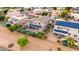 Aerial view of a home with a backyard pool, lush landscaping, and solar panels on the roof at 6971 W El Cortez Pl, Peoria, AZ 85383